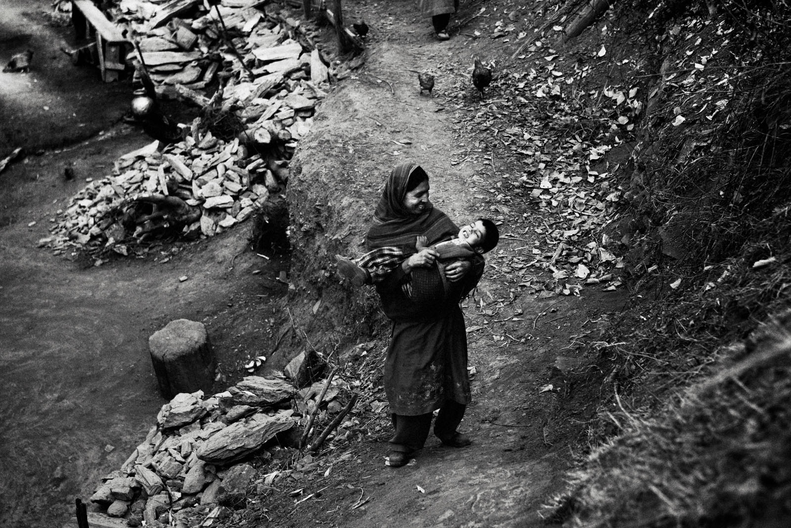 A women plays with her boy in Khudhalem, north Kashmir