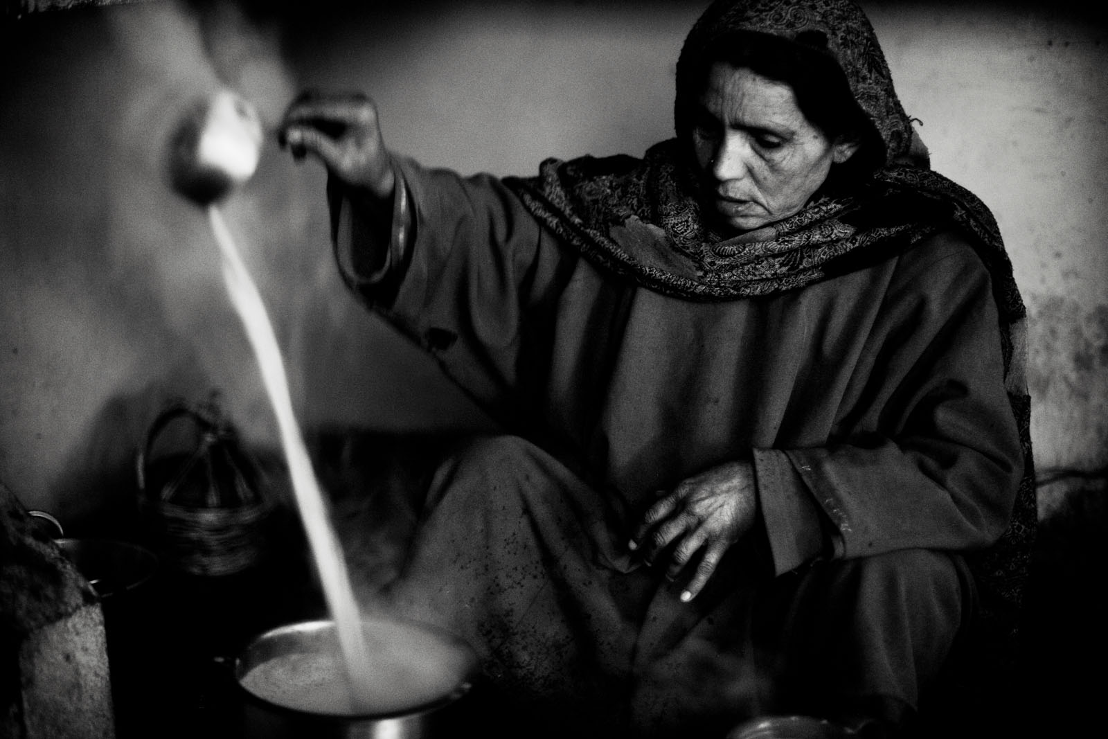 Khadija prepares tea in her home in north Kashmir